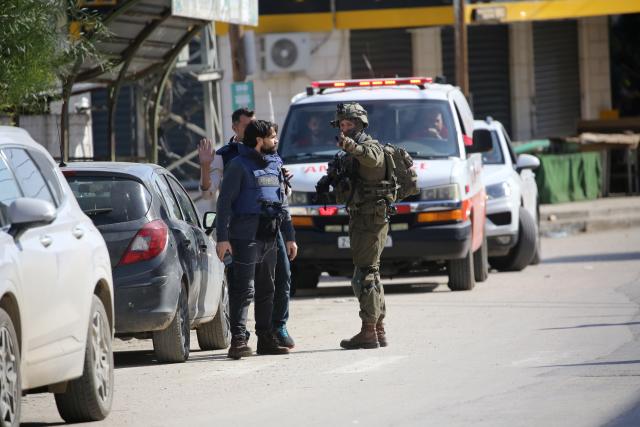 (251127) -- TUBAS, Nov. 27, 2025 (Xinhua) -- An Israeli soldier prevents Palestinian journalists from reporting during an Israeli military operation in the West Bank city of Tubas, on Nov. 27, 2025. At least 25 Palestinians were injured and 119 others detained in the northern West Bank city of Tubas as an Israeli military operation entered its second day, Palestinian officials said on Thursday. (Photo by Nidal Eshtayeh/Xinhua)