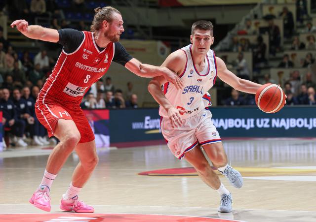 (251128) -- BELGRADE, Nov. 28, 2025 (Xinhua) -- Serbia's Stefan Miljenovic (L) defends Switzerland's Toni Rocak during the FIBA basketball World Cup 2027 European qualifiers first round group C match between Serbia and Switzerland in Belgrade, Serbia, Nov. 27, 2025. (Photo by Predrag Milosavljevic/Xinhua)