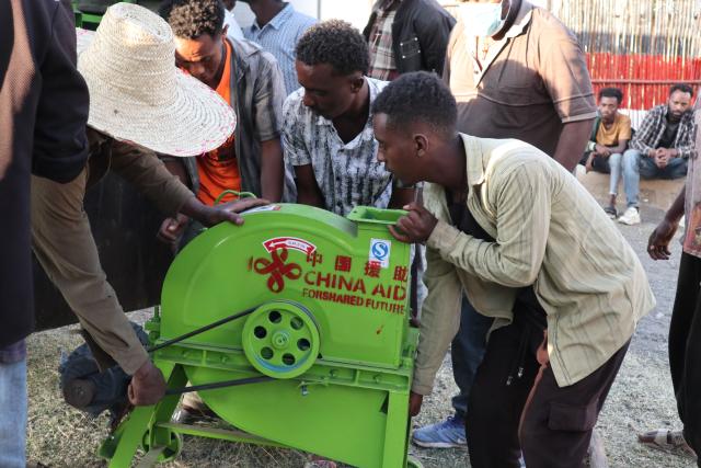 (251128) -- ADDIS ABABA, Nov. 28, 2025 (Xinhua) -- People move a piece of agricultural equipment donated by Chinese agricultural experts in Godino Jitu Village, Oromia region, Ethiopia, Nov. 26, 2025. TO GO WITH "Chinese donates agricultural materials to rural community in Ethiopia" (Xinhua/Liu Fangqiang)
