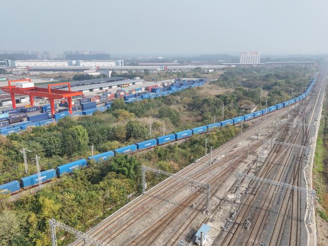 (251128) -- CHENGDU, Nov. 28, 2025 (Xinhua) -- An aerial drone photo taken on Nov. 28, 2025 shows the X8086 China-Europe freight train departing from the Chengdu International Railway Port in Chengdu, southwest China's Sichuan Province. As the X8086 train departed from Chengdu on Friday, the total number of China-Europe freight train trips has surpassed 120,000, with the total value of goods transported exceeding 490 billion U.S. dollars. (Xinhua/Wang Xi)