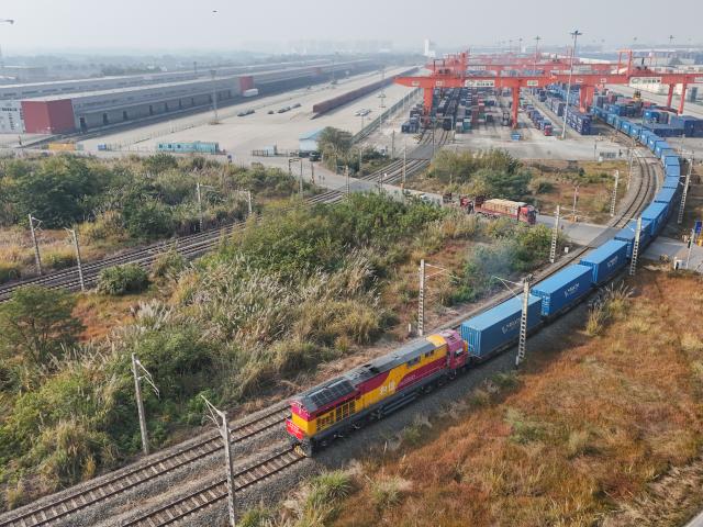 (251128) -- CHENGDU, Nov. 28, 2025 (Xinhua) -- An aerial drone photo taken on Nov. 28, 2025 shows the X8086 China-Europe freight train departing from the Chengdu International Railway Port in Chengdu, southwest China's Sichuan Province. As the X8086 train departed from Chengdu on Friday, the total number of China-Europe freight train trips has surpassed 120,000, with the total value of goods transported exceeding 490 billion U.S. dollars. (Xinhua/Wang Xi)