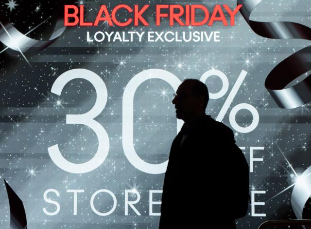 (251129) -- TORONTO, Nov. 29, 2025 (Xinhua) -- A man walks past a promotion sign of a shop during Black Friday sales event in Toronto, Canada, Nov. 28, 2025. (Photo by Zou Zheng/Xinhua)