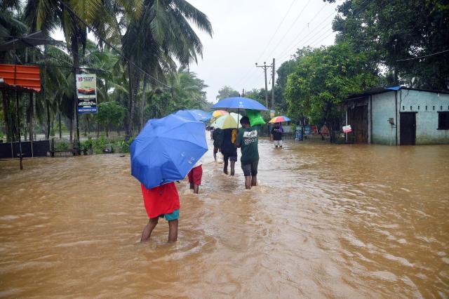 (251129) -- COLOMBO, Nov. 29, 2025 (Xinhua) -- People wade through a flooded street after heavy rains in Colombo, Sri Lanka, Nov. 28, 2025. Sri Lanka's Disaster Management Center (DMC) said on Saturday that the death toll from Cyclone Ditwah, which has been affecting the country in recent days, has climbed to 123, with 130 people still missing. (Photo by Ajith Perera/Xinhua)