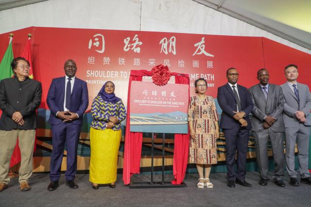 (251129) -- DAR ES SALAAM, Nov. 29, 2025 (Xinhua) -- Tanzanian Minister for Natural Resources and Tourism Ashatu Kijaji (3rd L), Chinese Ambassador to Tanzania Chen Mingjian (4th R), and other guests pose for a group photo at the opening ceremony of an art exhibition titled "Shoulder to Shoulder on the Same Path" held in Dar es Salaam, Tanzania, Nov. 26, 2025. An art exhibition has opened in Dar es Salaam, Tanzania, inviting spectators to explore both the storied past and the vibrant present of the Tanzania-Zambia Railway Authority (TAZARA), a lasting emblem of China-Africa friendship.
   TO GO WITH "Roundup: Art exhibition traces TAZARA legacy, China-Africa friendship" (Xinhua/Emmanuel Herman)