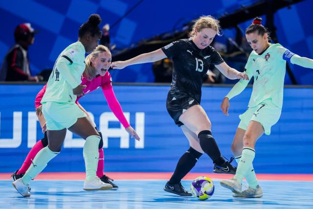 (251129) -- PASIG CITY, Nov. 29, 2025 (Xinhua) -- Ella James (2nd R) of New Zealand vies against players of Portugal during the group C match between Portugal and New Zealand at the FIFA Futsal Women's World Cup 2025 in Pasig City, the Philippines on Nov. 29, 2025. (Xinhua/Rouelle Umali)