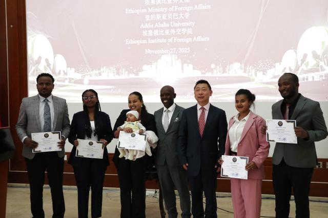 (251129) -- ADDIS ABABA, Nov. 29, 2025 (Xinhua) -- Guests pose for a group photo with young Ethiopian diplomats who have finished an online Chinese language training program in Addis Ababa, Ethiopia's capital, on Nov. 27, 2025. A ceremony has been held in Addis Ababa, Ethiopia's capital, to mark the completion of an online Chinese language training program for young Ethiopian diplomats. (Xinhua/Liu Fangqiang)
