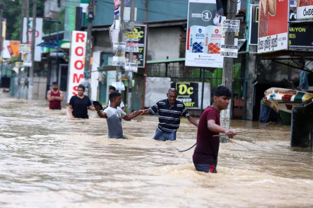 (251129) -- COLOMBO, Nov. 29, 2025 (Xinhua) -- People evacuate by wading through floodwater after heavy rains on the outskirts of Colombo, Sri Lanka, on Nov. 29, 2025. Sri Lankan President Anura Kumara Dissanayake has declared a State of Public Emergency effective on Friday, as the country confronts one of its worst weather-related disasters in recent years. (Photo by Ajith Perera/Xinhua)