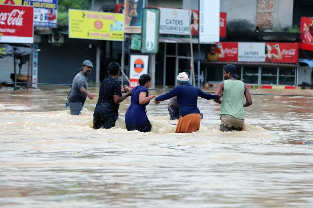 (251129) -- COLOMBO, Nov. 29, 2025 (Xinhua) -- People evacuate by wading through floodwater after heavy rains on the outskirts of Colombo, Sri Lanka, on Nov. 29, 2025. Sri Lankan President Anura Kumara Dissanayake has declared a State of Public Emergency effective on Friday, as the country confronts one of its worst weather-related disasters in recent years. (Photo by Ajith Perera/Xinhua)