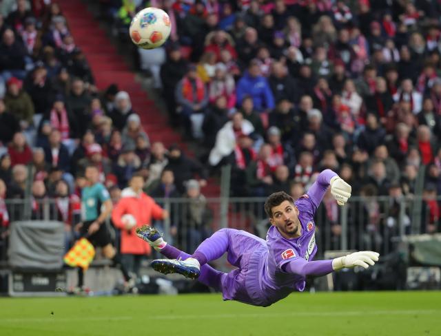 (251130) -- MUNICH, Nov. 30, 2025 (Xinhua) -- Nikola Vasilj, goalkeeper of FC St. Pauli, makes a save during the German first division Bundesliga football match between FC Bayern Munich and FC St. Pauli in Munich, Germany, Nov. 29, 2025. (Photo by Philippe Ruiz/Xinhua)