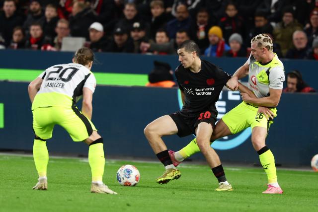 (251130) -- LEVERKUSEN, Nov. 30, 2025 (Xinhua) -- Ibrahim Maza (C) of Bayer 04 Leverkusen vies with Marcel Sabitzer (L) and Julian Ryerson of Borussia Dortmund during the German first division of Bundesliga football match between Bayer 04 Leverkusen and Borussia Dortmund in Leverkusen, Germany, Nov. 29. 2025. (Photo by Joachim Bywaletz/Xinhua)