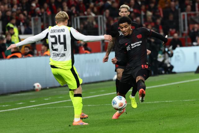 (251130) -- LEVERKUSEN, Nov. 30, 2025 (Xinhua) -- Malik Tillman (R, front) of Bayer 04 Leverkusen vies with Daniel Svensson (L) of Borussia Dortmund during the German first division of Bundesliga football match between Bayer 04 Leverkusen and Borussia Dortmund in Leverkusen, Germany, Nov. 29. 2025. (Photo by Joachim Bywaletz/Xinhua)