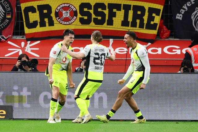 (251130) -- LEVERKUSEN, Nov. 30, 2025 (Xinhua) -- Players of Borussia Dortmund celebrate scoring during the German first division of Bundesliga football match between Bayer 04 Leverkusen and Borussia Dortmund in Leverkusen, Germany, Nov. 29. 2025. (Photo by Joachim Bywaletz/Xinhua)