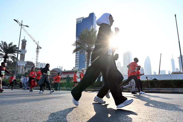 (251130) -- CAPITAL GOVERNORATE, Nov. 30, 2025 (Xinhua) -- People participate in a marathon race in Capital Governorate, Kuwait, Nov. 29, 2025. (Photo by Asad/Xinhua)