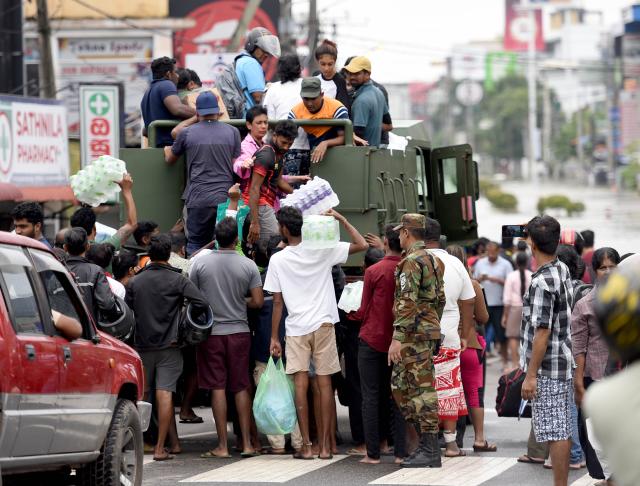 (251130) -- COLOMBO, Nov. 30, 2025 (Xinhua) -- Flood-affected people are transported to safe areas in Gampaha District, Sri Lanka, Nov. 29, 2025.
  Sri Lanka's Disaster Management Center (DMC) on Saturday evening said 153 people have died due to floods and landslides caused by Cyclone Ditwah. 
  The DMC said 774,724 people from 217,263 families across all districts have been affected by heavy rains, flooding, and landslides. It added that many areas remain inaccessible, complicating rescue efforts and relief distribution. (Photo by Gayan Sameera/Xinhua)