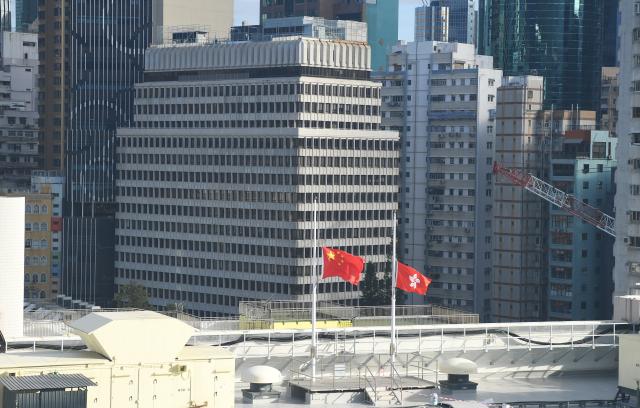 (251130) -- BEIJING, Nov. 30, 2025 (Xinhua) -- This photo taken on Nov. 29, 2025 shows the national flag and the Hong Kong Special Administrative Region (HKSAR) flag at the Queen Elizabeth Stadium flown at half-mast to mourn for the victims of the residential building fire in Hong Kong, south China.
  (Xinhua/Chen Duo)