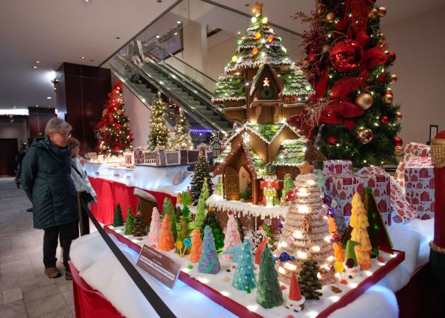 (251130) -- VANCOUVER, Nov. 30, 2025 (Xinhua) -- People look at gingerbread house creations during the annual "Gingerbread Lane" event in Vancouver, British Columbia, Canada, Nov. 29, 2025. Canada's longest-running gingerbread house display event returned for its 33rd year, featuring more than 30 gingerbread houses and inviting the public to vote for their favourite creations crafted by professional bakers, culinary artists, and culinary school students. (Photo by Liang Sen/Xinhua)