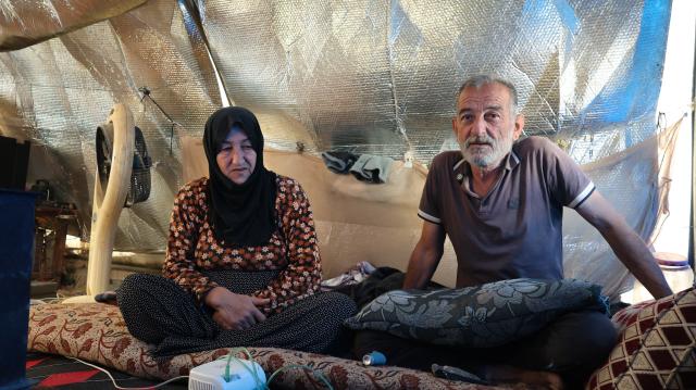 (251130) -- KHIRBET AL-JOZ, Nov. 30, 2025 (Xinhua) -- Nadia Kurdi and her husband Hassan Qurais, sit inside their tent at a camp in Khirbet al-Joz of northwestern Idlib province, Syria, Nov. 20, 2025.
  TO GO WITH "Feature: Stuck in tents and cut off from aid, displaced Syrians in NW border camp face another hard winter" (Str/Xinhua)