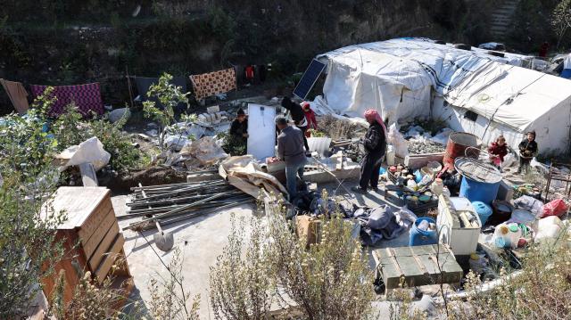 (251130) -- KHIRBET AL-JOZ, Nov. 30, 2025 (Xinhua) -- People sort through belongings outside their tents at a camp in Khirbet al-Joz of northwestern Idlib province, Syria, Nov. 20, 2025.
  TO GO WITH "Feature: Stuck in tents and cut off from aid, displaced Syrians in NW border camp face another hard winter" (Str/Xinhua)