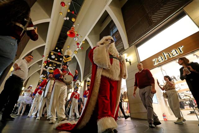 (251130) -- BEIRUT, Nov. 30, 2025 (Xinhua) -- People enjoy the Christmas atmosphere at the Beirut Souks in Beirut, Lebanon, Nov. 29, 2025. The Christmas season kicked off with the lighting of a Christmas tree and the unveiling of festive decorations at the Beirut Souks on Saturday night. (Xinhua/Bilal Jawich)