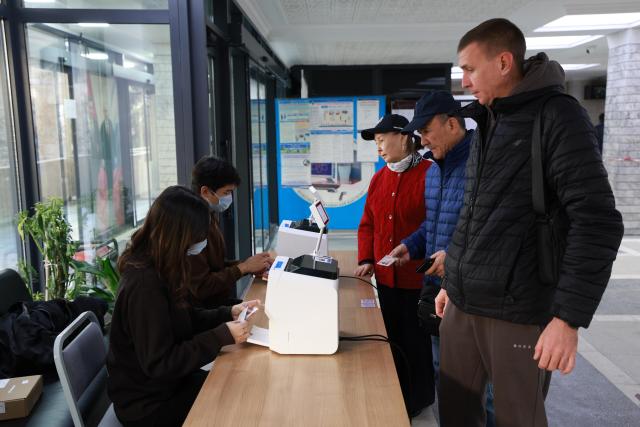 (251130) -- BISHKEK, Nov. 30, 2025 (Xinhua) -- Voters have their identities verified at a polling station in Bishkek, Kyrgyzstan, on Nov. 30, 2025. Early parliamentary elections began in Kyrgyzstan on Sunday to elect 90 deputies to the country's unicameral legislature. (Photo by Roman/Xinhua)
