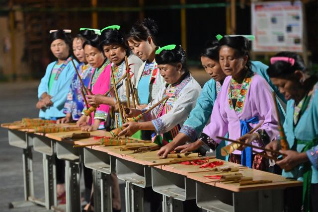 (251130) -- NANNING, Nov. 30, 2025 (Xinhua) -- Women participate in a competition for assembling Lusheng, a traditional reed-pipe wind instrument, in Rongshui Miao Autonomous County, south China's Guangxi Zhuang Autonomous Region, July 11, 2024. Rongshui County has leveraged its unique cultural resources of Lusheng to strengthen the inheritance of Miao ethnic culture and empower rural revitalization. (Xinhua/Huang Xiaobang)