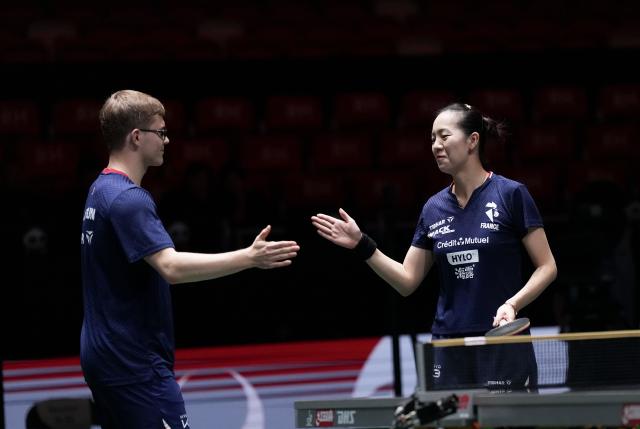 (251130) -- CHENGDU, Nov. 30, 2025 (Xinhua) -- Alexis Lebrun (L)/Jia Nan Yuan of France react during the mixed doubles match against Victoria Strassburger/Lucas Romanski of Brazil during the stage 1 group match between France and Brazil at the ITTF Mixed Team World Cup 2025 in Chengdu, southwest China's Sichuan Province, Nov. 30, 2025. (Xinhua/Wang Ying)