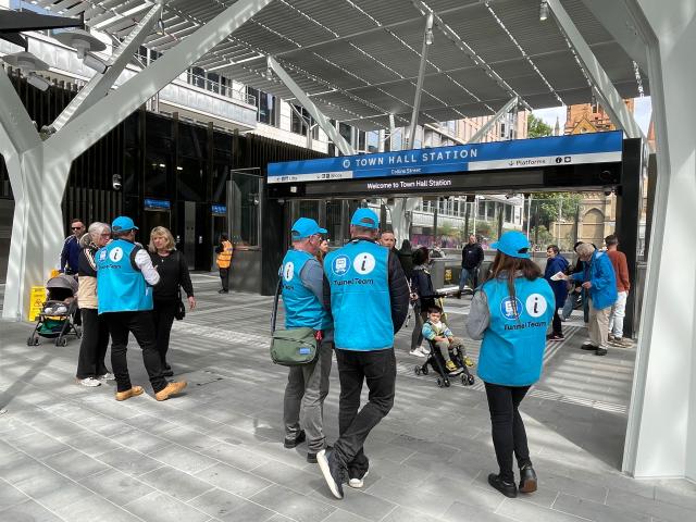 (251130) -- MELBOURNE, Nov. 30, 2025 (Xinhua) -- This photo taken with a mobile phone shows staff of the Metro Tunnel waiting at the entrance of the Town Hall Station to help passengers in Melbourne, Australia, on Nov. 30, 2025.
  Melbourne's new Metro Tunnel opened to passengers for the first time on Sunday following years of construction, marking a major expansion of the city's rail network.
  Limited services through the nine-kilometer twin tunnels and five new stations under Melbourne's central business district (CBD) began operating on Sunday morning, with some passengers queuing for hours in order to board the first trains. (Xinhua/Xu Haijing)
