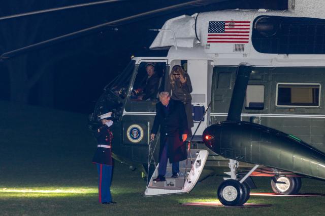 (251201) -- WASHINGTON, Dec. 1, 2025 (Xinhua) -- U.S. President Donald Trump and First Lady Melania Trump step off Marine One upon their arrival at the White House in Washington, D.C., the United States, Nov. 30, 2025. U.S. President Donald Trump confirmed on Sunday that he had a phone call with Venezuelan President Nicolas Maduro, but refused to reveal any details of the call, according to The New York Times. (Xinhua/Hu Yousong)