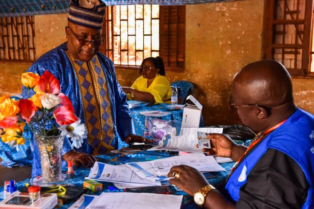 (251201) -- BANGANTE, Dec. 1, 2025 (Xinhua) -- An election official verifies a voter's identity before issuing the ballot during Cameroon's regional elections at a polling station in Bangante, Cameroon, Nov. 30, 2025. Voting for Cameroon's regional elections began early Sunday, with polling starting nationwide at 8 a.m. (0700 GMT) local time.
  Municipal councilors and traditional rulers will elect 900 regional councilors to serve five-year terms, with 90 in each of the country's 10 regions. (Xinhua/Kepseu)