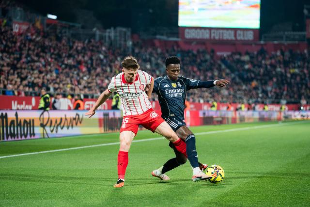 (251201) -- GIRONA, Dec. 1, 2025 (Xinhua) -- Vinicius Junior (R) of Real Madrid CF vies with Viktor Tsyhankov of Girona FC during the La Liga football match between Girona FC and Real Madrid CF in Montilivi Stadium, Girona, Spain, on Nov. 30, 2025. (Photo by Joan Gosa/Xinhua)