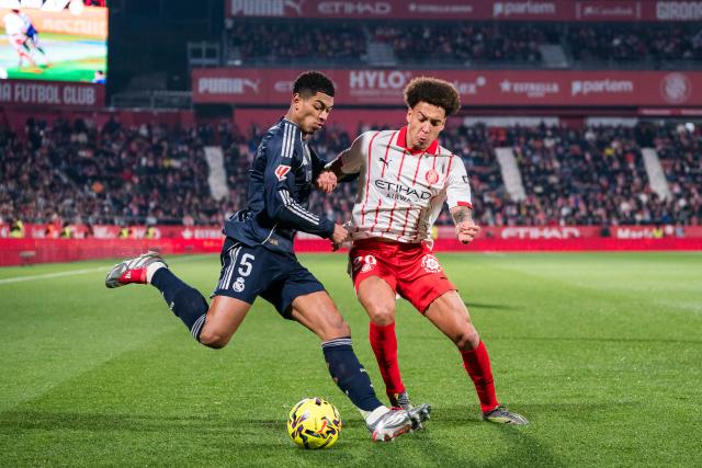 (251201) -- GIRONA, Dec. 1, 2025 (Xinhua) -- Jude Bellingham (L) of Real Madrid CF vies with Axel Witsel of Girona FC during the La Liga football match between Girona FC and Real Madrid CF in Montilivi Stadium, Girona, Spain, on Dec. 1, 2025. (Photo by Joan Gosa/Xinhua)