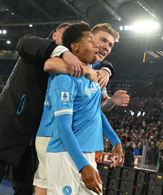 (251201) -- ROME, Dec. 1, 2025 (Xinhua) -- Napoli's David Neres (L) celebrates his goal with his teammate Rasmus Hojlund during a Serie A soccer match between Roma and Napoli in Rome, Italy, Nov. 30, 2025. (Photo by Alberto Lingria/Xinhua)