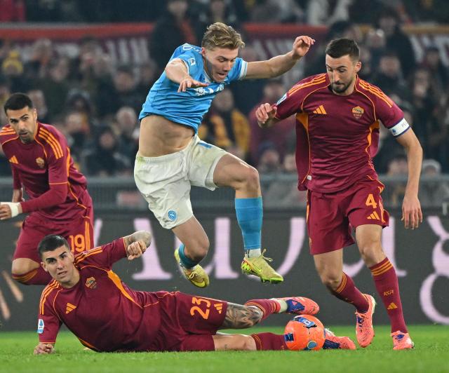 (251201) -- ROME, Dec. 1, 2025 (Xinhua) -- Napoli's Rasmus Hojlund (top) vies with Roma's Gianluca Mancini (bottom) and Bryan Cristante (R) during a Serie A soccer match between Roma and Napoli in Rome, Italy, Nov. 30, 2025. (Photo by Alberto Lingria/Xinhua)
