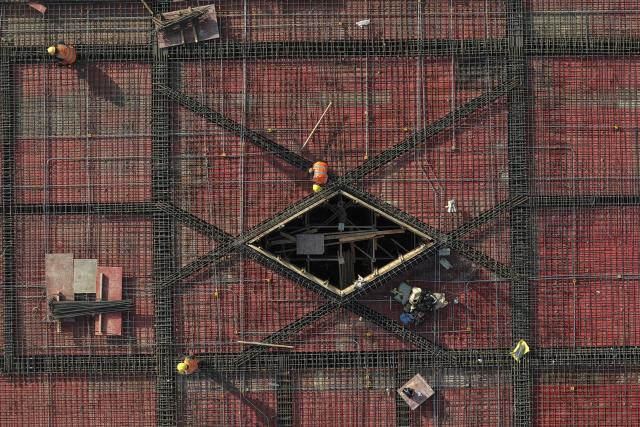 (251201) -- HUAIBEI, Dec. 1, 2025 (Xinhua) -- An aerial drone photo taken on Nov. 30, 2025 shows laborers working at the construction site of a square in front of Huaibei West Railway Station in Huaibei, east China's Anhui Province. The Huaibei West Railway Station is along an intercity railway stretching about 161 kilometers which will link the cities of Huaibei, Suzhou and Bengbu in Anhui Province. (Xinhua/Huang Bohan)