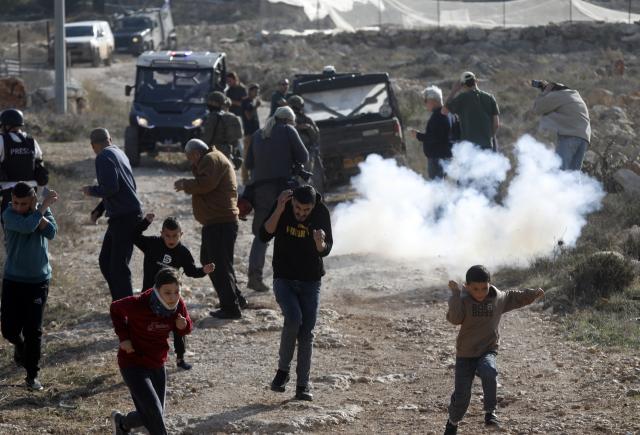 (251201) -- BEIJING, Dec. 1, 2025 (Xinhua) -- Palestinians take shelter from tear gases fired by Israeli forces in the village of Tarqumiyah, west of Hebron in the West Bank, on Nov. 28, 2025.
  Israeli security forces and settlers have killed 1,030 Palestinians in the occupied West Bank, including East Jerusalem, since Oct. 7, 2023, the United Nations Office of the High Commissioner for Human Rights (OHCHR) has verified, a UN spokesperson said here Friday.
   Among the fatalities were 223 children, Jeremy Laurence, spokesperson for the OHCHR, told a regular UN press briefing in Geneva. (Photo by Mamoun Wazwaz/Xinhua)