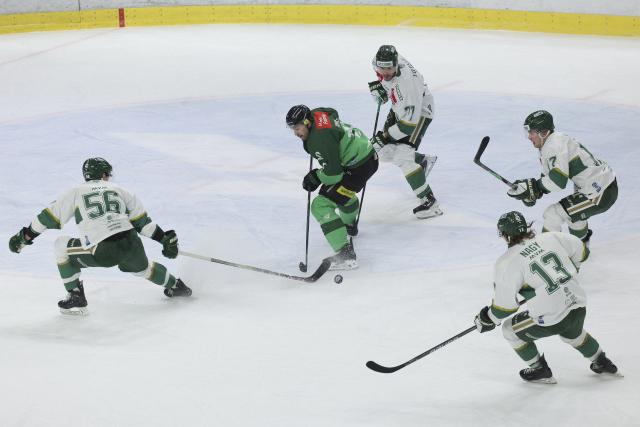 (251201) -- LJUBLJANA, Dec. 1, 2025 (Xinhua) -- Ziga Pance (2nd L) of Olimpija Ljubljana controls the puck during the 2025/26 win2day Ice Hockey League match between Olimpija Ljubljana and FTC Telekom in Ljubljana, Slovenia, Nov. 30, 2025. (Photo by Zeljko Stevanic/Xinhua)
