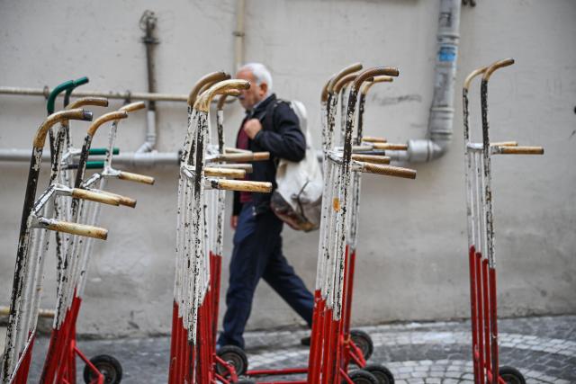 (251201) -- ISTANBUL, Dec. 1, 2025 (Xinhua) -- A porter walks past a row of handcarts in the Eminonu commercial district of Istanbul, Türkiye, Nov. 6, 2025. In the old quarters of Istanbul, one often encounters a familiar scene: men weaving through narrow streets, carrying heavy loads on their backs or pushing them on handcarts. Known in Turkish as "hamal," these traditional porters represent a profession that dates back to the Ottoman era and endures to this day.
   The porters'tools are simple -- a thick shoulder strap or a sturdy handcart. Dozens of kilograms, sometimes even loads exceeding a hundred kilograms, are lifted and transported with steady precision before disappearing into the maze-like streets.
   The Grand Bazaar, the Spice Bazaar, and the commercial district of Eminonu are among Istanbul's oldest and busiest trading hubs. Dense shopfronts, heavy foot traffic, and a network of narrow alleys and intersections leave little room for motor vehicles, which have allowed the hamal profession to survive and remain indispensable.
   In these labyrinthine streets, they shoulder countless small-scale logistics tasks, quietly sustaining the commercial lifeblood of the city. In Istanbul, being a porter is not only a traditional craft -- it is a foundational force that has supported the city's commercial vitality for centuries. (Xinhua/Liu Lei)
