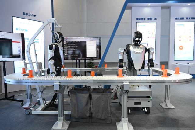 (251201) -- FUZHOU, Dec. 1, 2025 (Xinhua) -- This photo shows robots displayed at the Third Overseas Chinese Talent Conference for Development in Fuzhou, southeast China's Fujian Province, Dec. 1, 2025. Under the theme of "Uniting Overseas Chinese Talent, Forging a New Era of Innovation," the Third Overseas Chinese Talent Conference for Development kicked off here on Monday. (Xinhua/Zhou Yi)