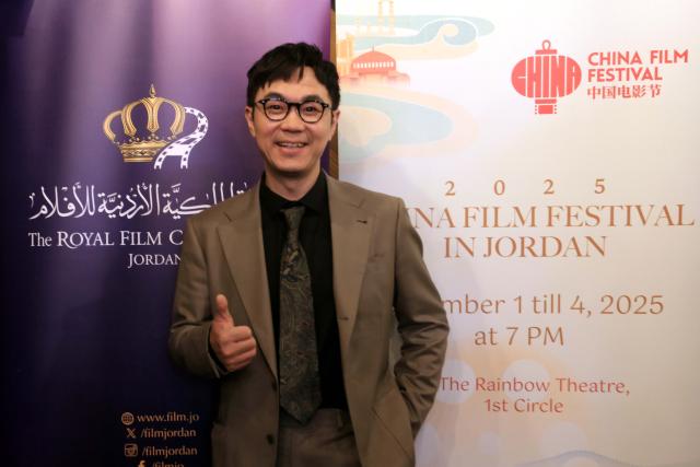 (251202) -- AMMAN, Dec. 2, 2025 (Xinhua) -- Da Peng, director and lead actor of The Lychee Road, poses for photos at the 2025 China Film Festival in Amman, Jordan, on Dec. 1, 2025. The 2025 China Film Festival kicked off Monday evening in the Jordanian capital Amman, attracting a full-house audience.
    Running for four days until Thursday, the festival features four Chinese films: Dead to Rights, The Sinking of Lisbon Maru, I Am What I Am 2, and The Lychee Road. (Photo by Mohammad Abu Ghosh/Xinhua)
