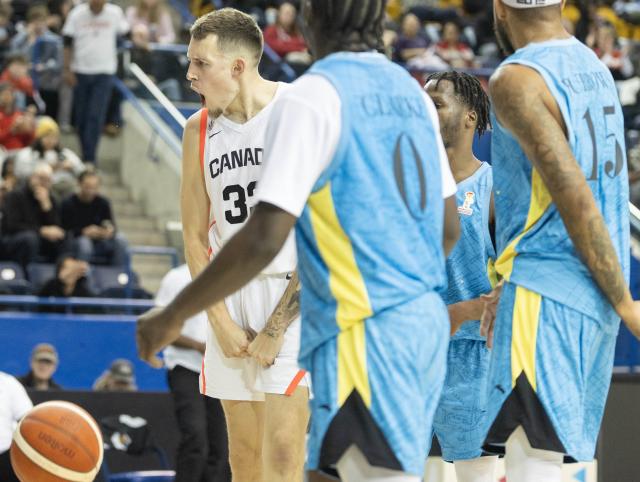 (251202) -- TORONTO, Dec. 2, 2025 (Xinhua) -- Kyle Wiltjer (L) of Canada celebrates scoring during the first round group match of the FIBA Basketball World Cup 2027 Americas Qualifiers between Canada and Bahamas in Toronto, Canada, on Dec. 1, 2025. (Photo by Zou Zheng/Xinhua)