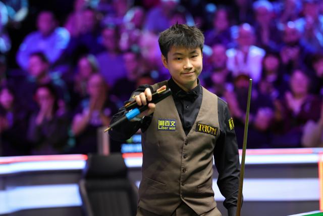 (251202) -- YORK, Dec. 2, 2025 (Xinhua) -- Zhao Xintong of China celebrates after winning the first round match against Long Zehuang of China at the 2025 UK Snooker Championship in York, Britain, Dec. 1, 2025. (Photo by Zhai Zheng/Xinhua)