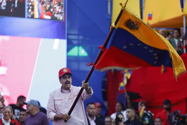 (251202) -- CARACAS, Dec. 2, 2025 (Xinhua) -- Venezuelan President Nicolas Maduro waves the Venezuelan national flag during a rally in Caracas, capital of Venezuela, Dec. 1, 2025. Venezuela does not want "a slave's peace," Venezuelan President Nicolas Maduro told supporters Monday as U.S. military deployment has been "testing" his country for months.
   "We want peace, but peace with sovereignty, peace with equality, peace with freedom; we do not want the peace of slaves or the peace of colonies. A colony never, slaves never," Maduro declared, noting that the 22-week U.S. military "aggression" can be described as "psychological terrorism." (Str/Xinhua)