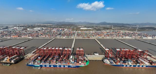 (251202) -- NINGBO, Dec. 2, 2025 (Xinhua) -- An aerial drone photo taken on Dec. 2, 2025 shows container ships berthing at the Meishan port area of the Ningbo-Zhoushan Port in east China's Zhejiang Province. A container adorned in red was steadily loaded onto a container ship here on Tuesday, marking the Ningbo-Zhoushan Port's annual container throughput exceeding 40 million TEUs for the first time.
   The Ningbo-Zhoushan Port is the only port in the world that has handled over 1 billion tonnes of cargo annually for 16 consecutive years. (Xinhua/Weng Xinyang)