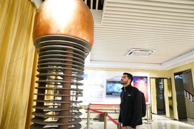 (251202) -- HEFEI, Dec. 2, 2025 (Xinhua) -- Ahmed Medhat Mostafa Elsayed looks at a model of a proton electrostatic accelerator at the history gallery of University of Science and Technology of China in Hefei, east China's Anhui Province, Nov. 28, 2025. The 23-year-old Ahmed Medhat Mostafa Elsayed is an Egyptian student who is currently doing research in particle physics at the University of Science and Technology of China in Hefei.
    Elsayed came to China at the age of ten in 2012. Influenced by his father, who works in the physics area, Elsayed gradually developed a strong interest in physics. After graduating from Sichuan University of Science and Engineering with a bachelor's degree in physics two years ago, he entered the University of Science and Technology of China for his postgraduate study. 
    Now Elsayed, whose research topic focuses on heavy neutrinos, plans to apply for the doctoral degree here, hoping he could make some influential scientific research achievements in the future and  could become a bridge on academic exchange between China and the world. (Xinhua/Du Yu)