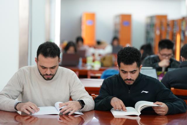 (251202) -- HEFEI, Dec. 2, 2025 (Xinhua) -- Ahmed Medhat Mostafa Elsayed (R) and his Egyptian classmate read at the library of University of Science and Technology of China in Hefei, east China's Anhui Province, Nov. 28, 2025. The 23-year-old Ahmed Medhat Mostafa Elsayed is an Egyptian student who is currently doing research in particle physics at the University of Science and Technology of China in Hefei.
    Elsayed came to China at the age of ten in 2012. Influenced by his father, who works in the physics area, Elsayed gradually developed a strong interest in physics. After graduating from Sichuan University of Science and Engineering with a bachelor's degree in physics two years ago, he entered the University of Science and Technology of China for his postgraduate study. 
    Now Elsayed, whose research topic focuses on heavy neutrinos, plans to apply for the doctoral degree here, hoping he could make some influential scientific research achievements in the future and  could become a bridge on academic exchange between China and the world. (Xinhua/Du Yu)