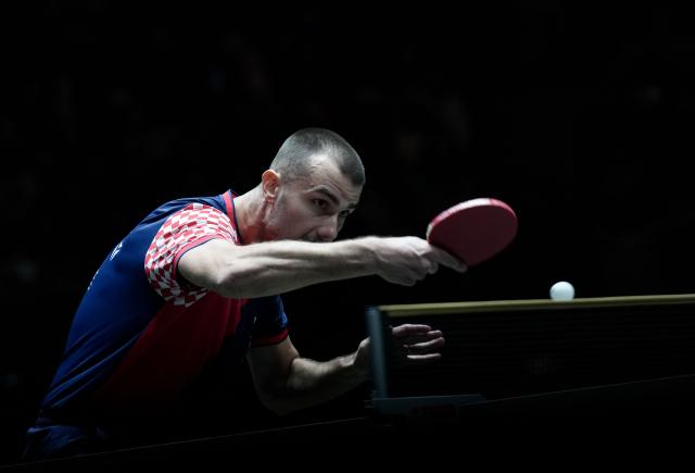 (251202) -- CHENGDU, Dec. 2, 2025 (Xinhua) -- Tomislav Pucar of Croatia his a return in the men's singles match against Harimoto Tomokazu of Japan during the stage 1 group match between Japan and Croatia at the ITTF Mixed Team World Cup 2025 in Chengdu, southwest China's Sichuan Province, Dec. 2, 2025. (Xinhua/Wang Ying)
