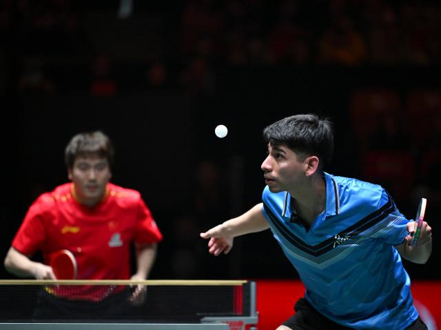 (251202) -- CHENGDU, Dec. 2, 2025 (Xinhua) -- Gustavo Gomez of Chile (R) competes in the men's singles match against Liang Jingkun of China during the stage 1 group match between China and Chile at the ITTF Mixed Team World Cup 2025 in Chengdu, southwest China's Sichuan Province, Dec. 2, 2025. (Xinhua/Xu Bingjie)
