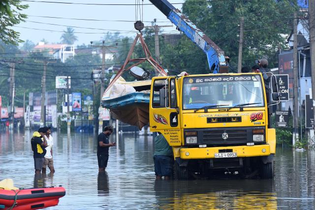 (251202) -- COLOMBO, Dec. 2, 2025 (Xinhua) -- A rescue boat is transported by a crane truck through a flooded street in Colombo, Sri Lanka, on Dec. 1, 2025. The death toll from extreme weather conditions hitting Sri Lanka has risen to 410, while 336 people remain missing, the country's Disaster Management Center said Tuesday. (Photo by Gayan Sameera/Xinhua)