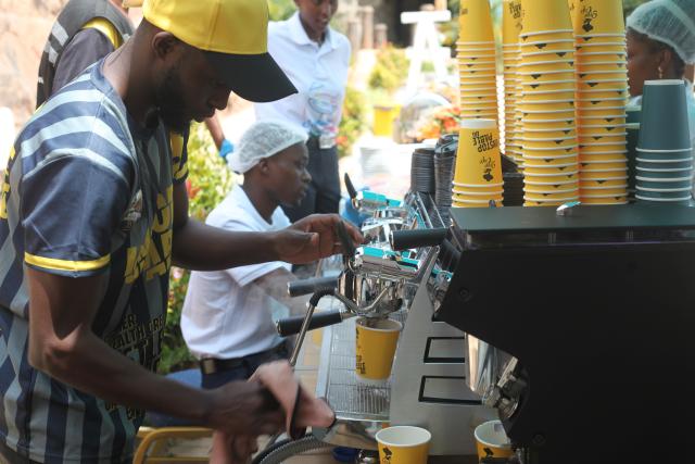 (251202) -- NTUNGAMO, Dec. 2, 2025 (Xinhua) -- A man makes coffee at the African Coffee Park in western Ugandan district of Ntungamo on Nov. 28, 2025. TO GO WITH "China's zero-tariff policy opens new doors for Ugandan coffee exports: entrepreneur " (Photo by Ronald Ssekandi/Xinhua)