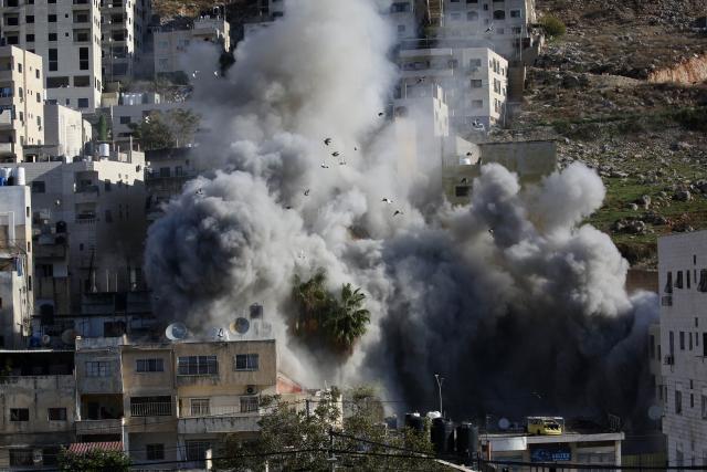 (251202) -- NABLUS, Dec. 2, 2025 (Xinhua) -- Smoke rises as Israeli forces blow up a Palestinian house in the West Bank city of Nablus, Dec. 2, 2025. (Photo by Nidal Eshtayeh/Xinhua)